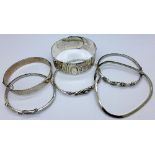 Six silver and white metal bangles,