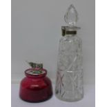 A ruby glass preserve with plated top and cow finial and a cut crystal glass decanter with lockable