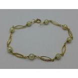 A yellow metal and seed pearl bracelet