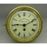 A brass clock, marked Henry Braowne & Son Ltd.