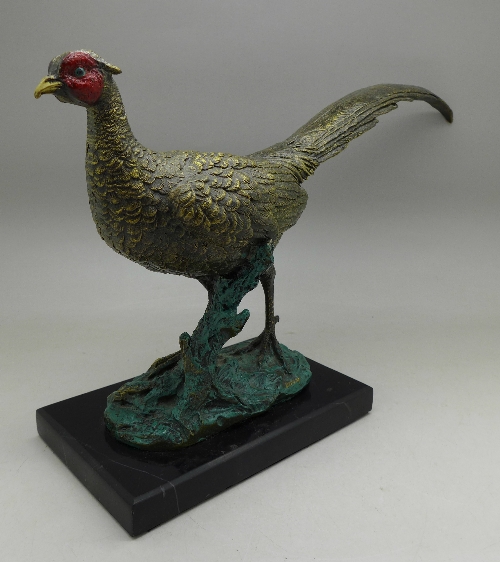 A cast, cold painted model of a pheasant on a base, width of base 14.