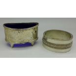 A Victorian white metal bangle and a silver salt, 92.