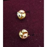 A pair of 9ct gold studs