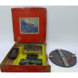 A tin-plate O gauge clockwork model rail set and a Hornby turntable