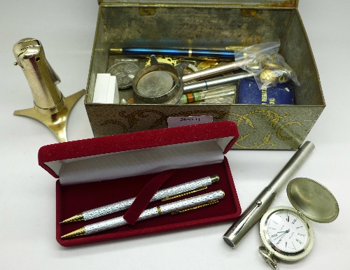 Commemorative crowns, a Ronson table lighter, badges, buttons, pens, etc.