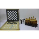 A marble chess set with board and two other chess sets