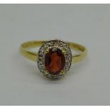 A 9ct gold, diamond and garnet ring, 1.