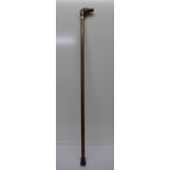 A walking cane with horse head handle