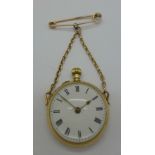 A 9ct gold cased pendant ball watch, suspended on a yellow metal pin and chain,