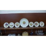 A set of six Rosenthal plates and one larger plate decorated with fruit