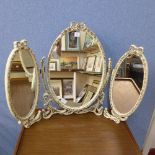 A cream and parcel gilt dressing table mirror