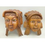 A pair of carved face wall plaques, 20th Century,