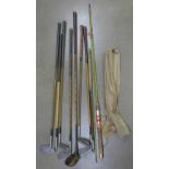 Eight golf clubs and a Milbio Spinwell fishing rod