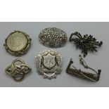 Six silver brooches including one made from a fob medal