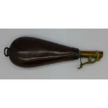 A leather and brass powder flask