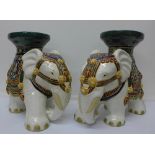 A pair of elephant jardiniere stands