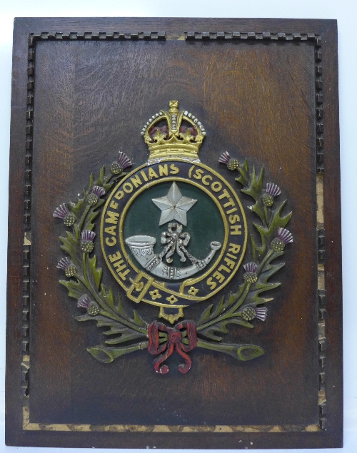 A carved wooden regimental coat of arms,