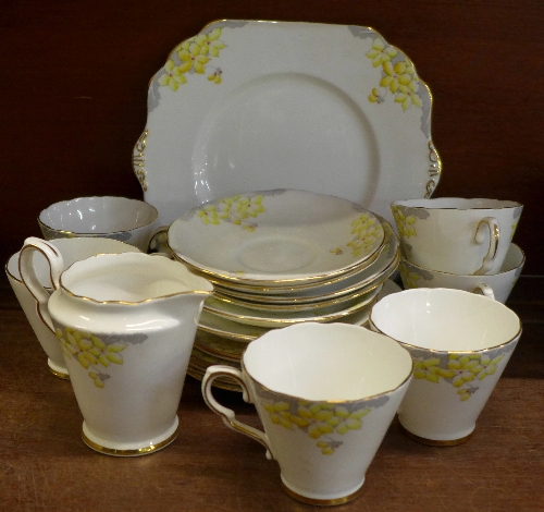 A six setting Art Deco tea service comprising a cake plate, six cups, saucers,