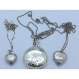 Three silver lockets and chains