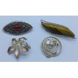 Four silver brooches,