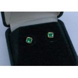 A pair of 18ct gold and emerald stud earrings