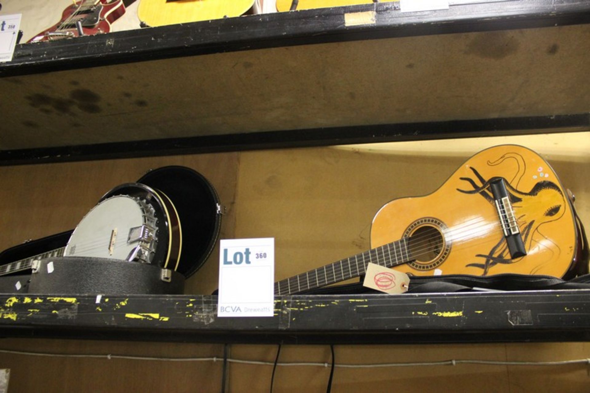 An Aria AK-20 Guitar in case and a Westfield banjo in case.