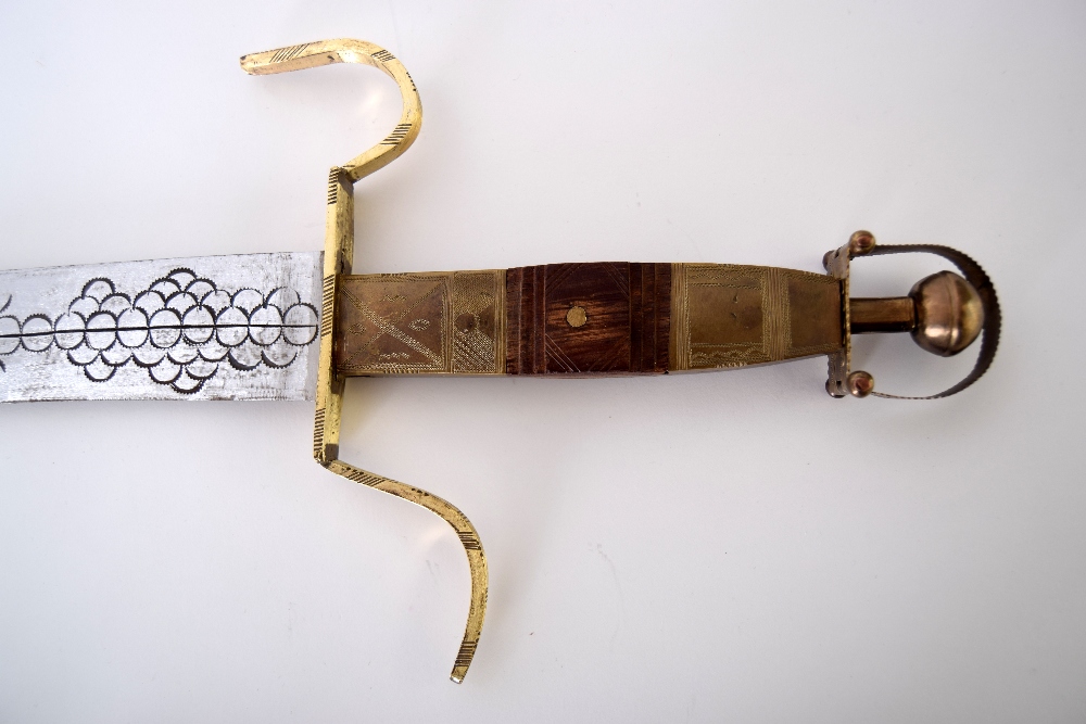 An early 20th century Tuareg/Berber curved sword and thick leather scabbard with traditional - Image 2 of 3