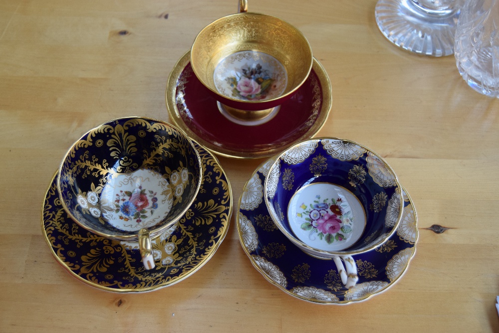 A collection of decorative tea cups and saucers including Aynsley 'Royalty' and Paragon china