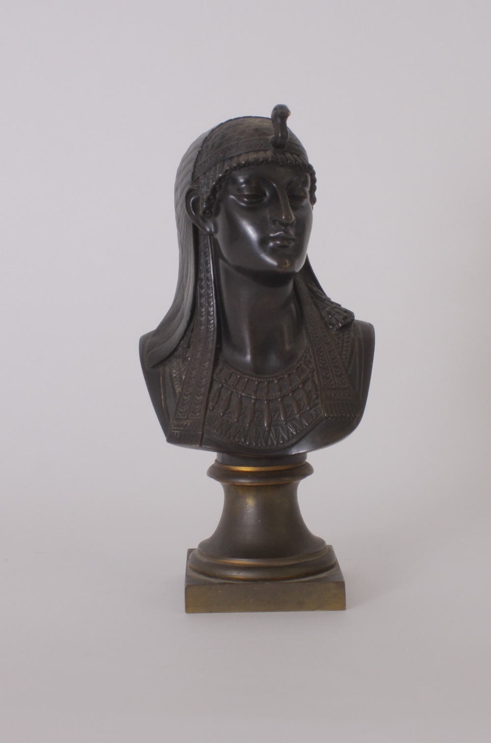 A 19th century orientalist bronze bust of an Egyptian Queen with an ibis headress facing to