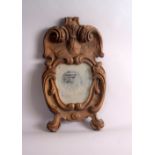 An Italian 18th century giltwood frame, of cartouche form with a foliate carved S-scroll crest,