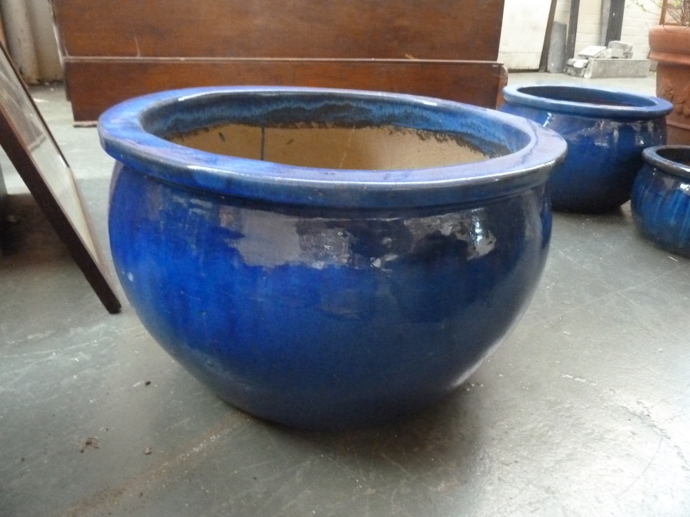 A large round stoneware planter, blue glazed,