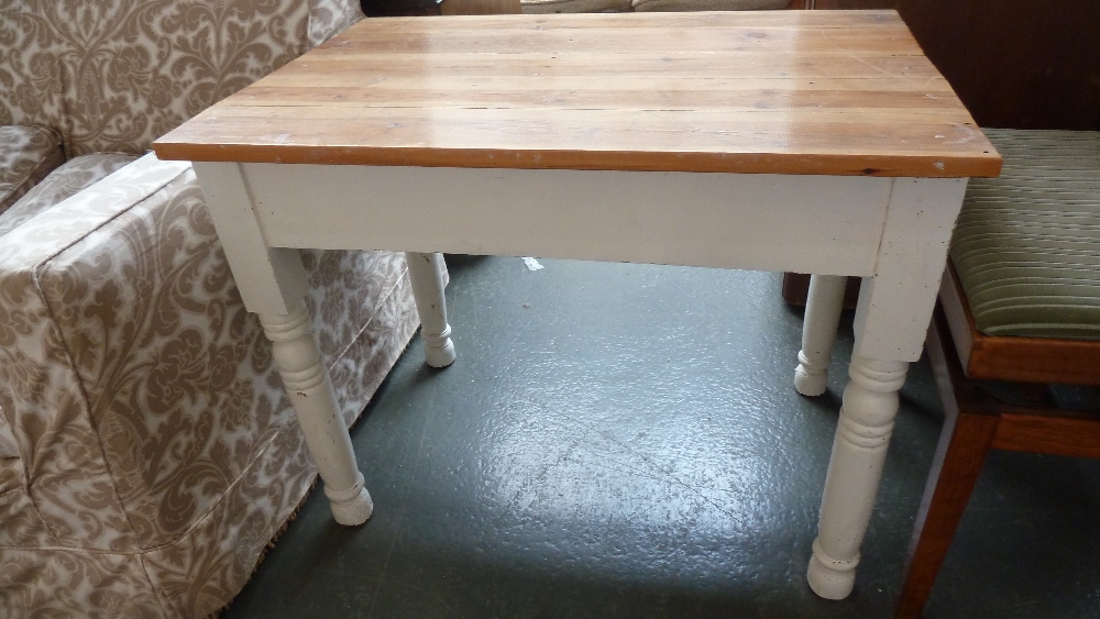 A painted small kitchen table with pine plank top and tuned legs