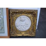 A marble style square plaque depicting a cherub group, framed,