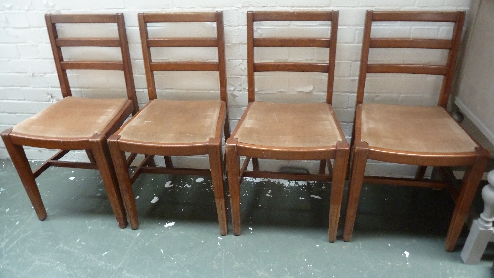 A set of four 20th century oak bar back dining chairs with beige drop in seats together with a