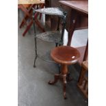 A green painted cast iron three tier pot stand 70cmH together with a small tripod table