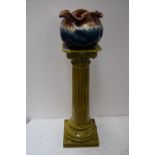 A green glazed ceramic pot stand in the form of a classical fluted column together with a brown and