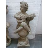 A composite stone figure seated on an orb playing a lute,