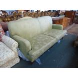 A modern three seater sofa, green floral upholstery,