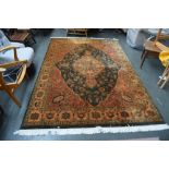 A rug with multiple floral borders and a large central diamond with orange and red fields together