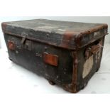 A large canvas and leather strapped trunk labelled Army & Navy Co-Operative,