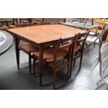 A 1970's Scandinavian style teak extending dining table with four of chairs ensuite