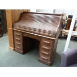 An early 20th century oak roll top desk, probably American,