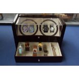 A watch display cabinet with several watches including, Redherring, Identity, Reflex,