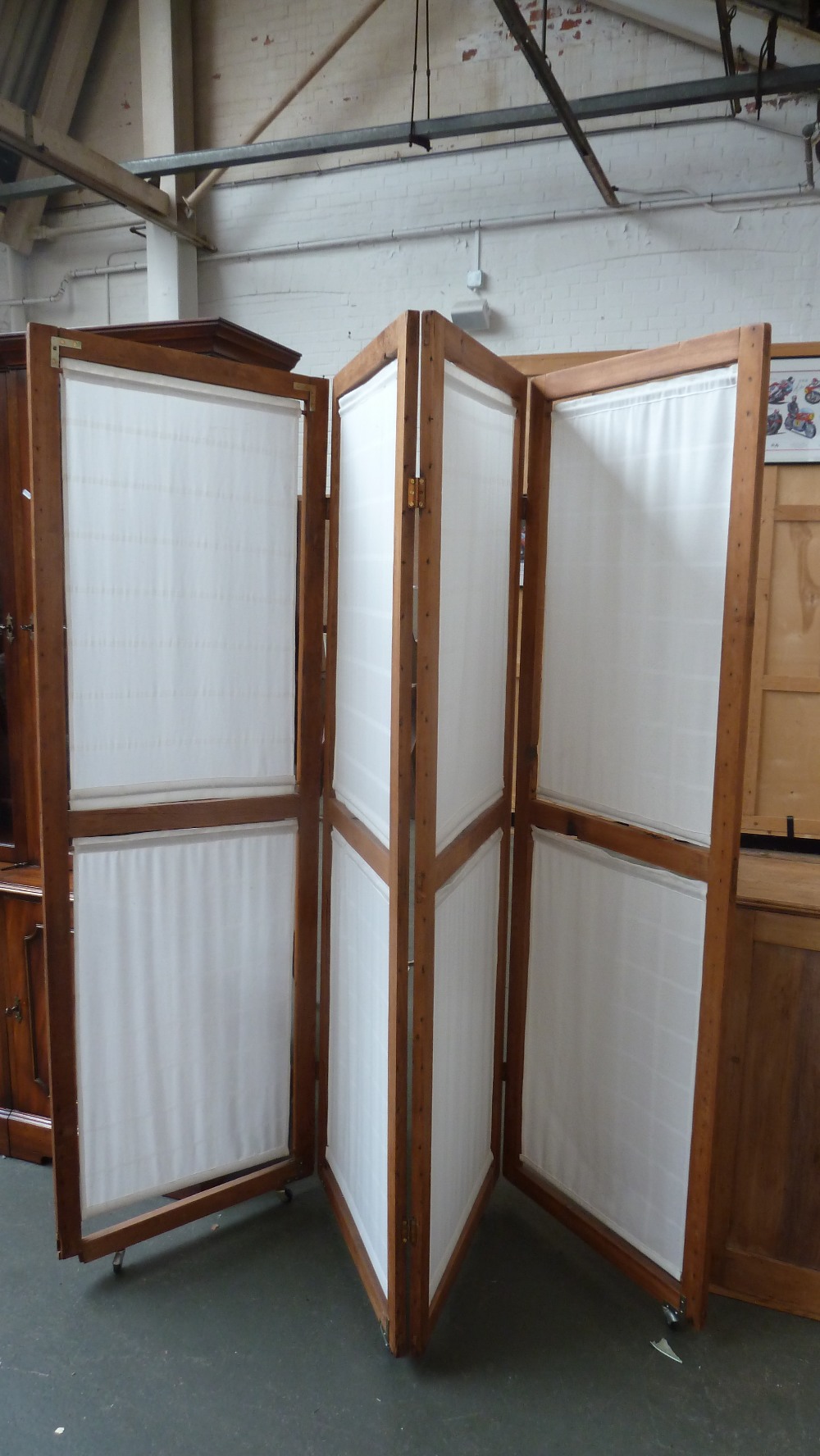 A pine four section screen with linen panels