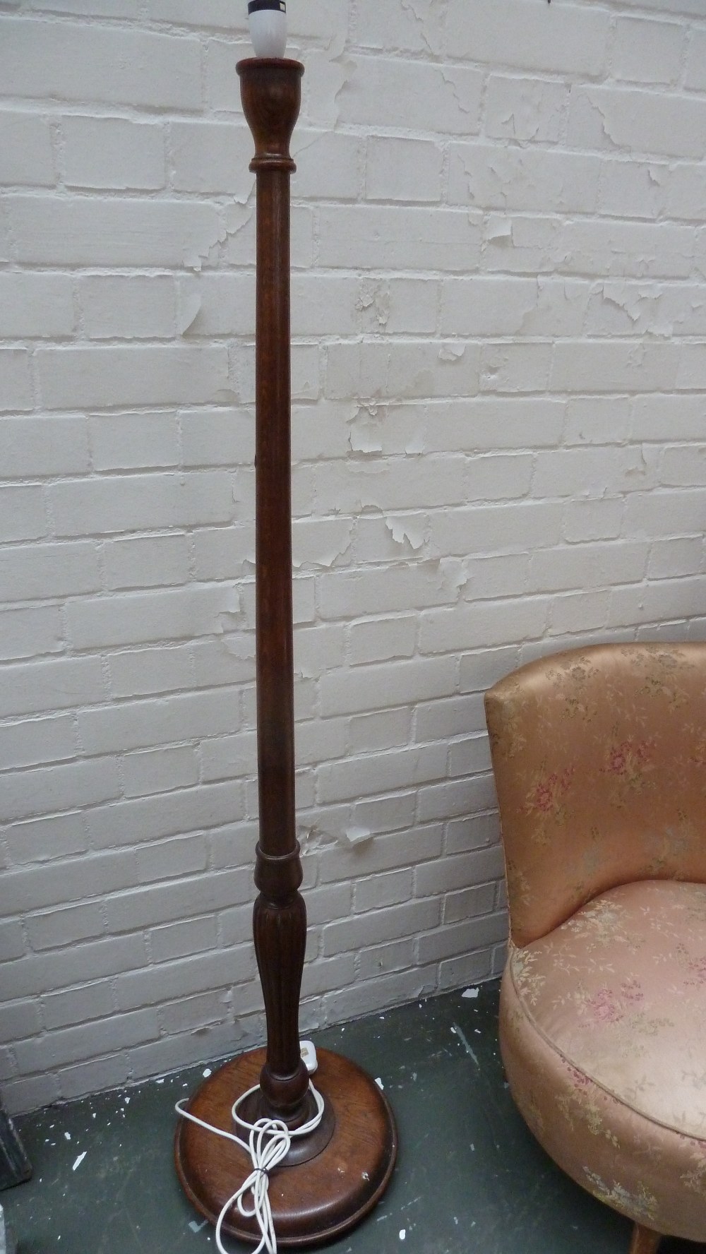 A 20th century oak standard lamp partially fluted stem over turned base