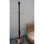 A 20th century oak standard lamp partially fluted stem over turned base