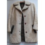 A ladies vintage sheepskin jacket with a tartan wool lining, leather trim and wooden buttons.