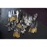 A selection of silver plated items of flatware including mother of pearl handle knife and forks,