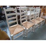 A set of four painted slat back chairs with rush seats (4)