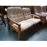 A Domino 20th century design Danish teak framed two seater sofa with oatmeal fabric